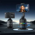 Two motorized camera mounts on moon like terrain, one holding a camera and one a smartphone with 360° rotation.